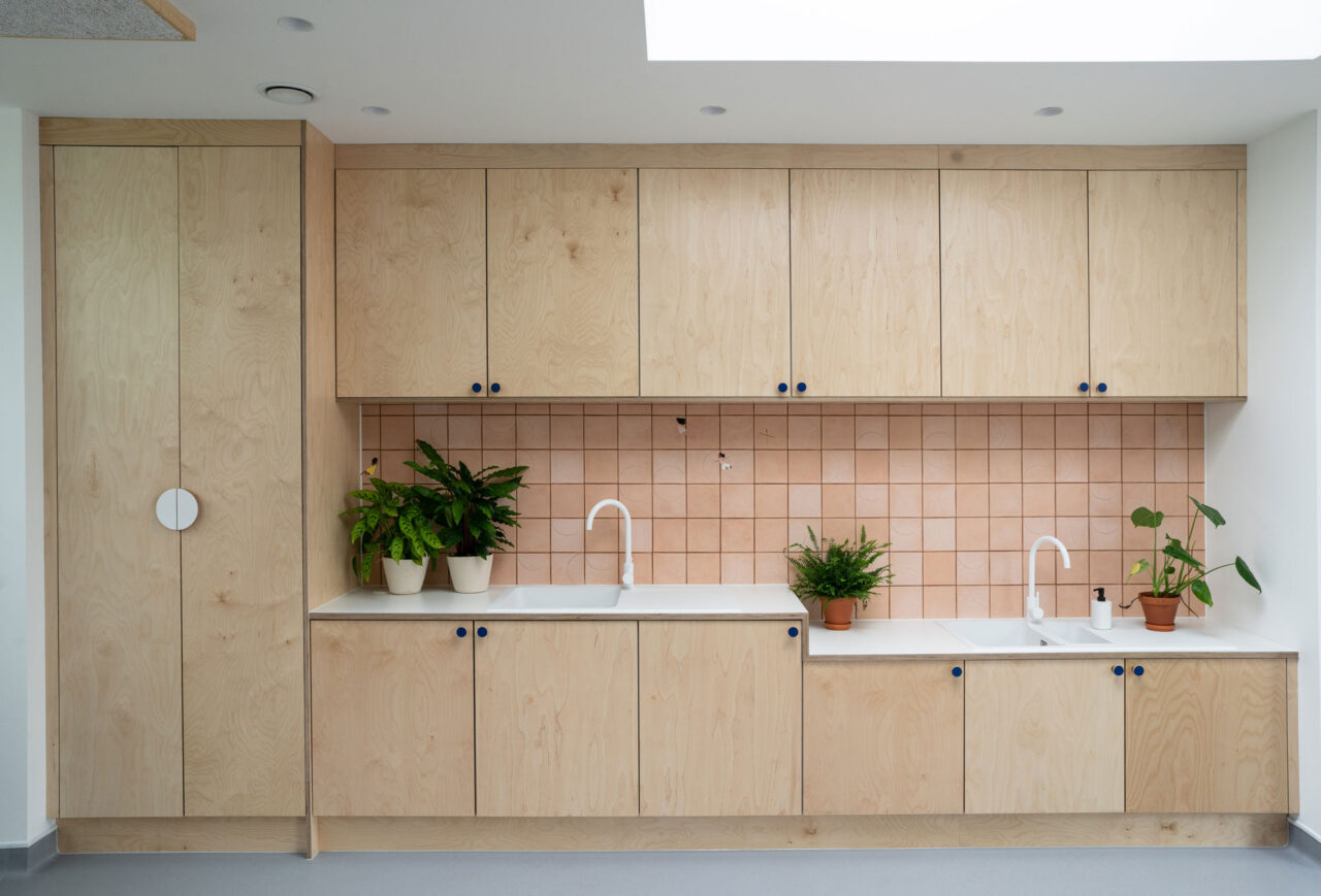 Wooden storage cupboards and sink area at Goldfinch Create and Play